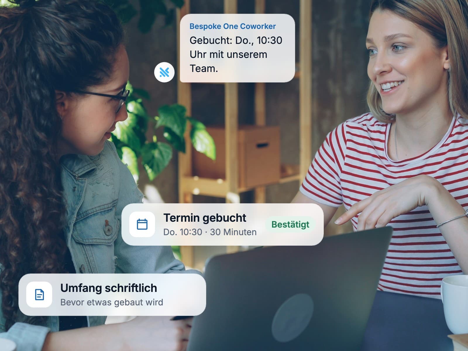 Two colleagues smiling at a laptop after booking a call