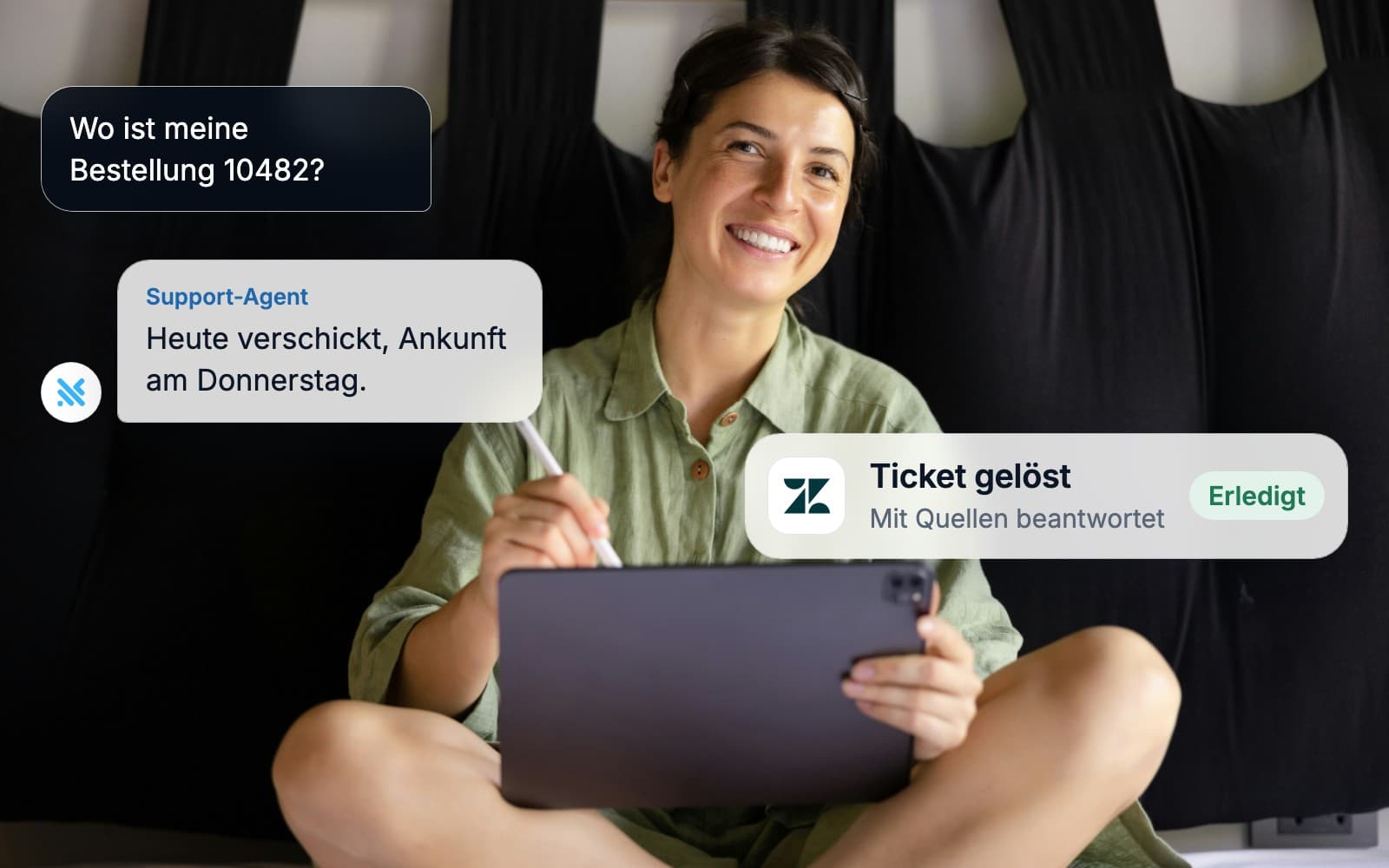 A woman with a tablet smiling while an AI agent answers a customer and updates the ticket