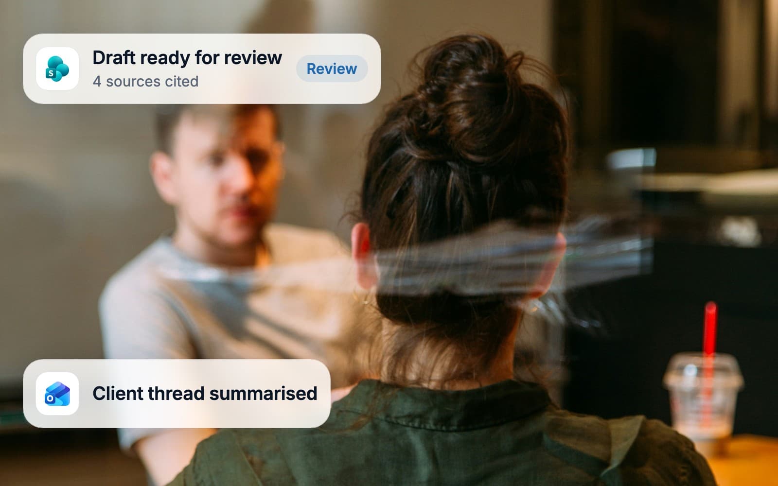 Two advisers in a meeting while a drafted document waits for partner review