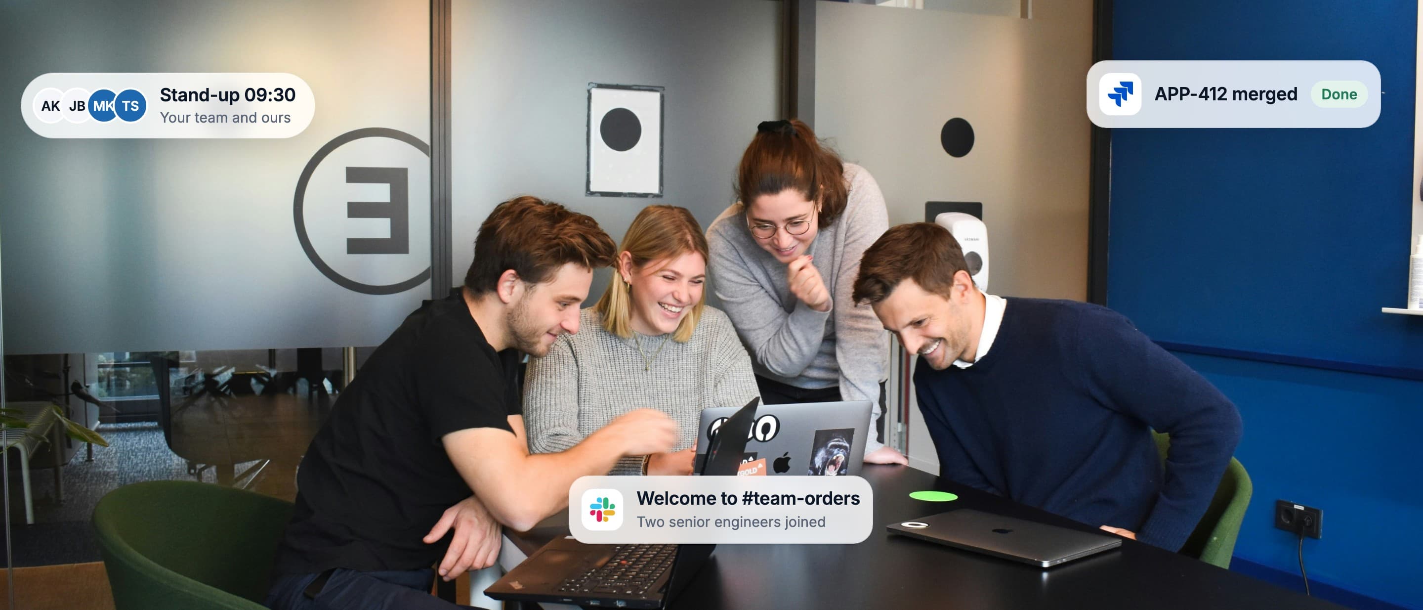 Three engineers working through a change together on one laptop